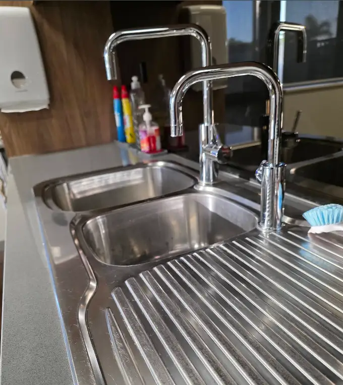 Polished stainless steel sinks and taps
