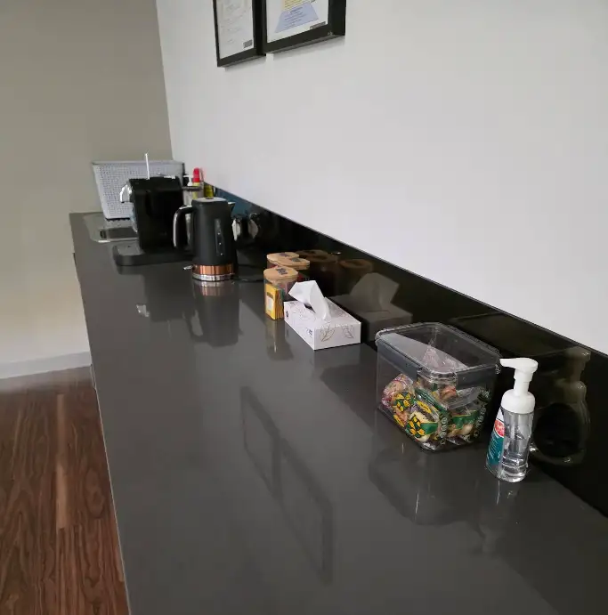 Office kitchen countertop with kettle and supplies